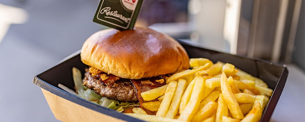 Zubereitung eines Burgers mit Pommes Frites im INTERSPAR-Foodtruck