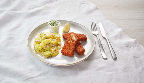 Frisch gebackener, panierter Fisch mit Kartoffelsalat und Sauce