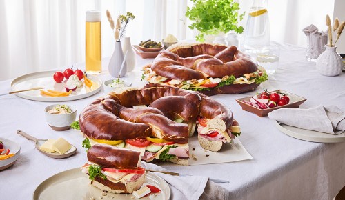 Eine gedeckter Tisch mit Partybrezen, Bier und Snacks