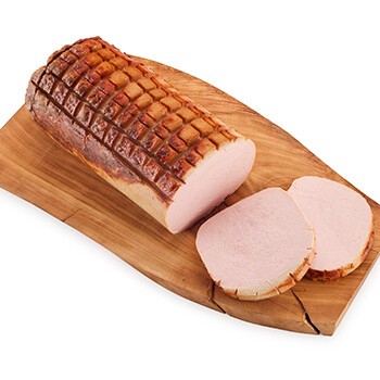 Ein gebackener Leberkäse auf einem Brett