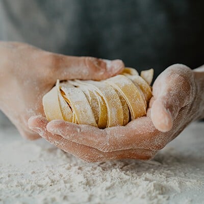 Eine Person bei der Zubereitung traditioneller italienischer hausgemachter Pasta