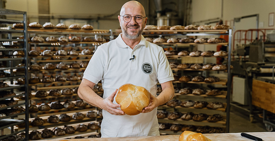 Bäckermeister Johann Pilz mit seinem INTERSPAR Bäckerliebling, der Pinze