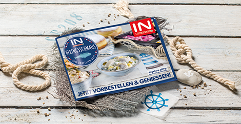 Ein INTERSPAR Heringsschmaus-Flyer auf einem Tisch