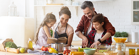 Glückliche Familie, die gemeinsam mit den Kindern in der Küche kocht. 
